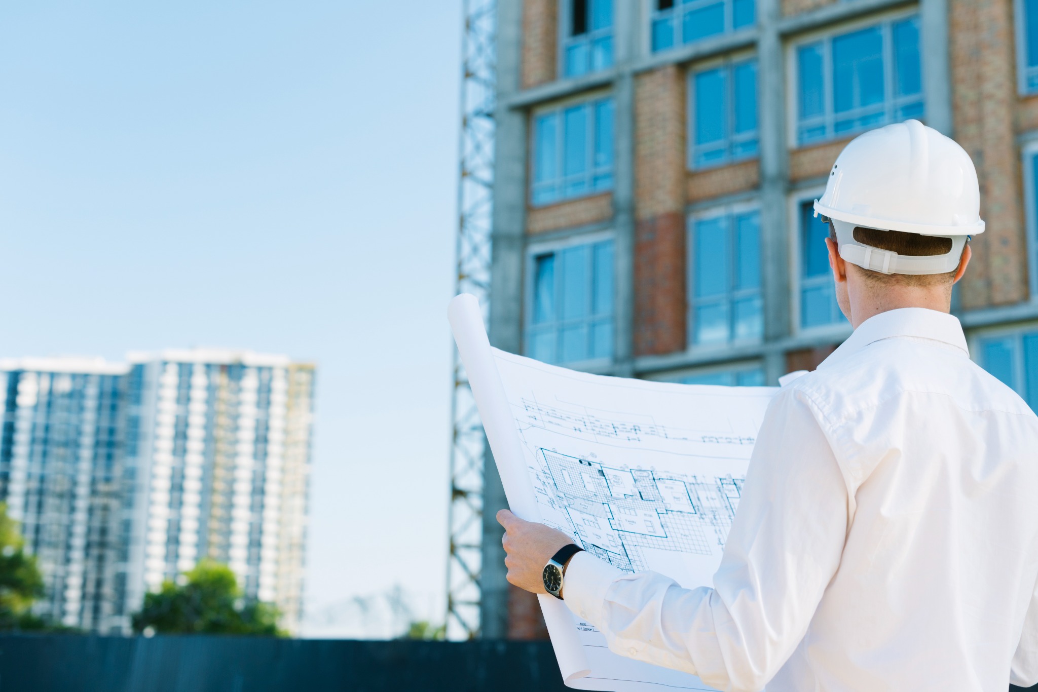 Engineer reviewing building plans on site
